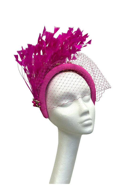 Magenta headband with veiling and feathers for hire