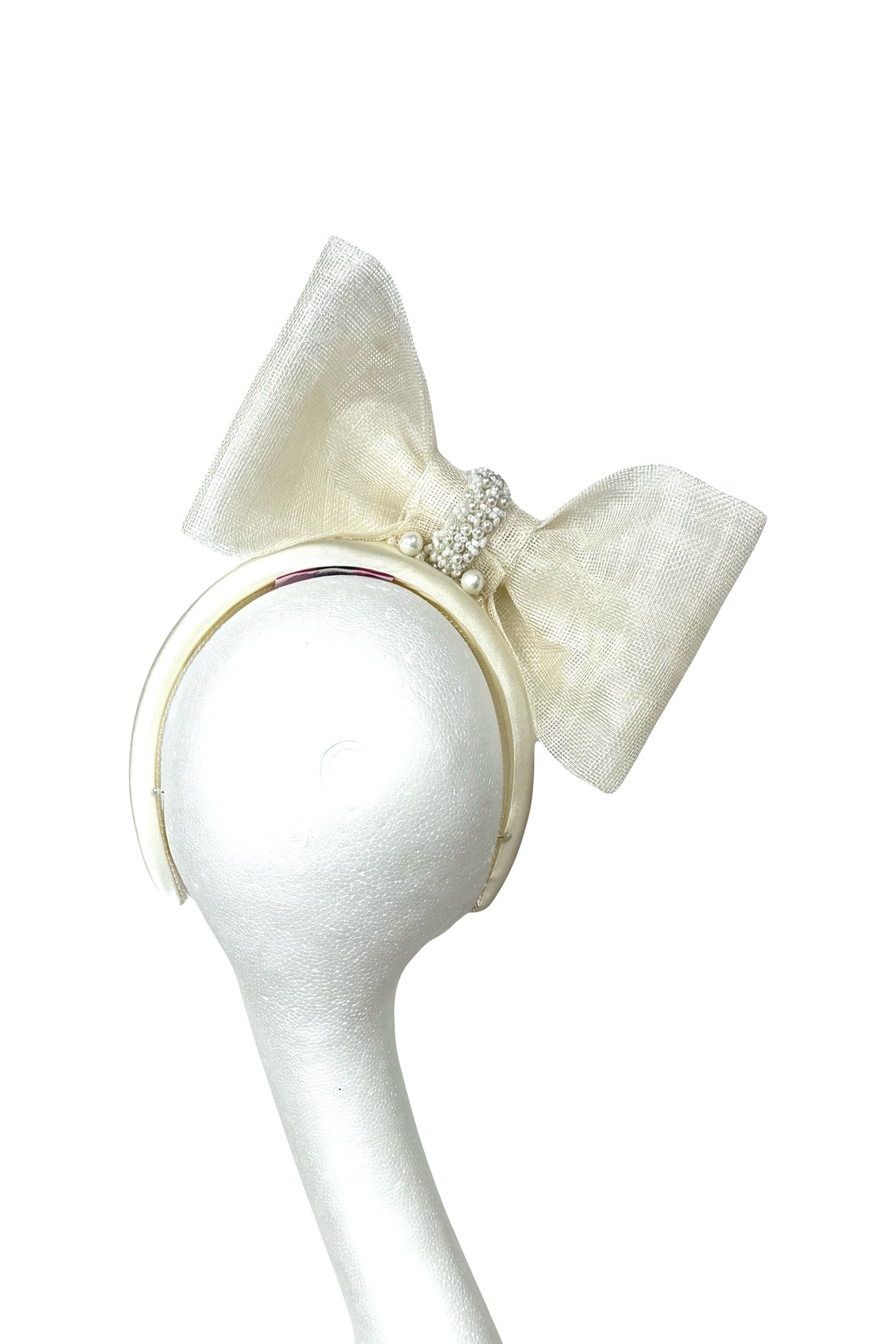 White headband with a large bow on a white background
