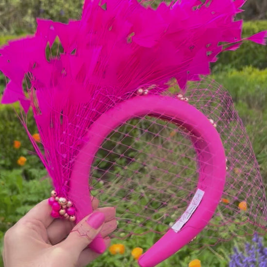 Magenta headband with veiling and feathers for hire