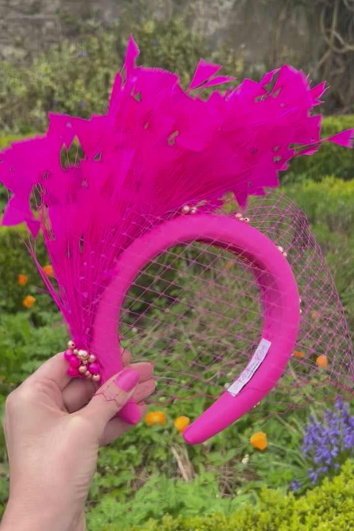 Magenta headband with veiling and feathers for hire